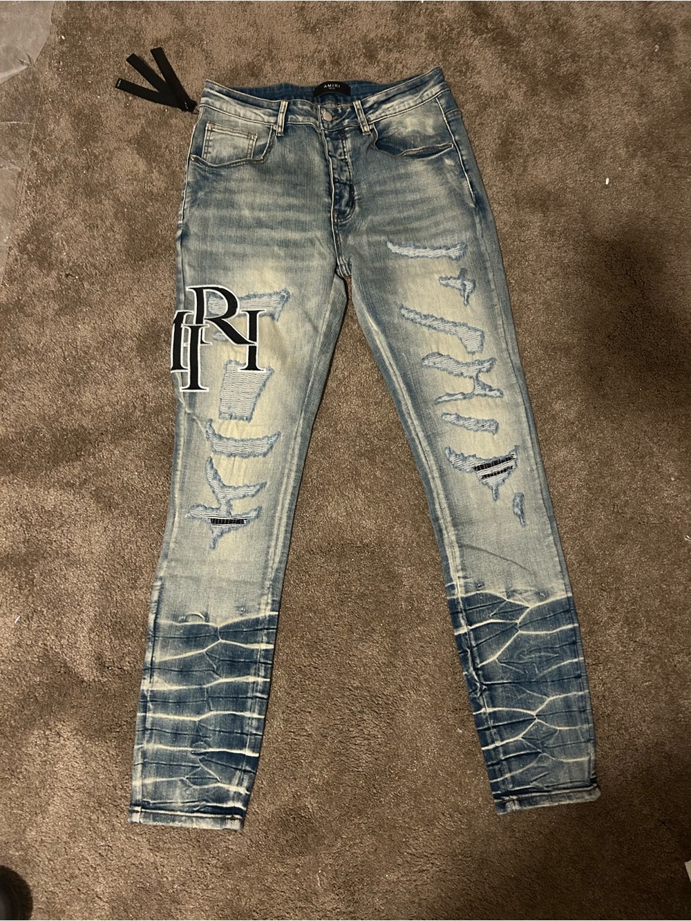 AMIRI Light Blue Distressed Skinny Jeans with Embroidered Patch